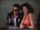 a man and a woman are sitting at a table .