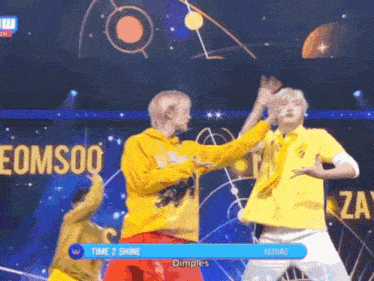 a group of people dancing on a stage with a sign that says time 2 shine on it