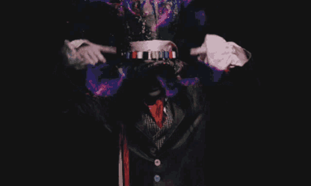 a man wearing a top hat and white gloves is pointing