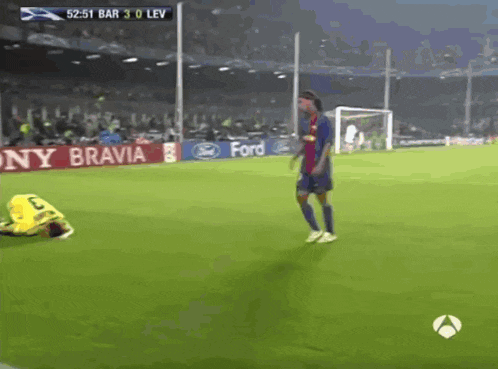 a soccer game is being played on a field with a banner for sony bravia