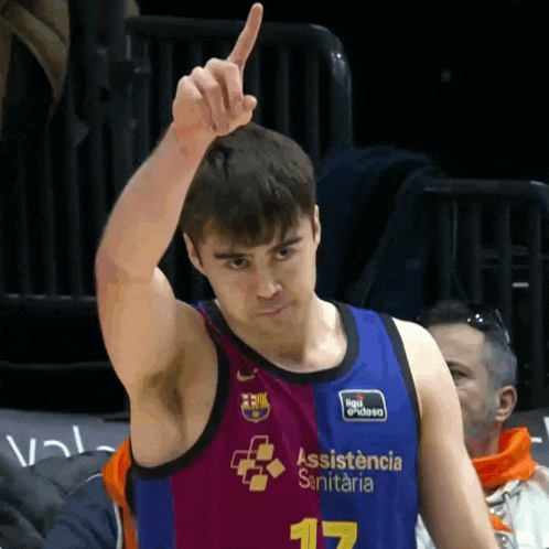 a man wearing a basketball jersey that says assistencia sanitaria on it