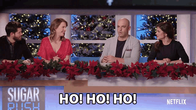 a group of people sitting at a table with the words ho ho ho