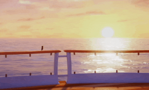 the sun is setting over the ocean behind the railing
