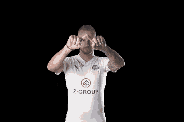 a man wearing a white shirt that says z group