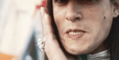 a woman is talking on a cell phone while making a funny face .