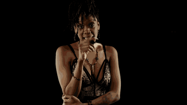 a woman with a tattoo on her arm is holding a lollipop