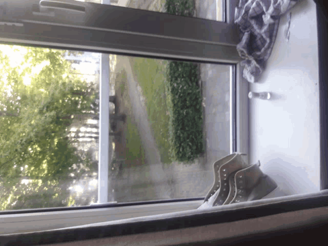 a pair of shoes sitting on a window sill