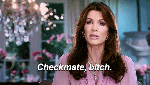 a woman in a pink dress is sitting in a chair and says checkmate bitch .