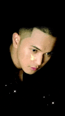 a man is surrounded by black and gold balloons and confetti with the word hap written on the bottom