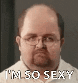 a bald man with glasses and a beard is wearing a white shirt and says `` i 'm so sexy '' .