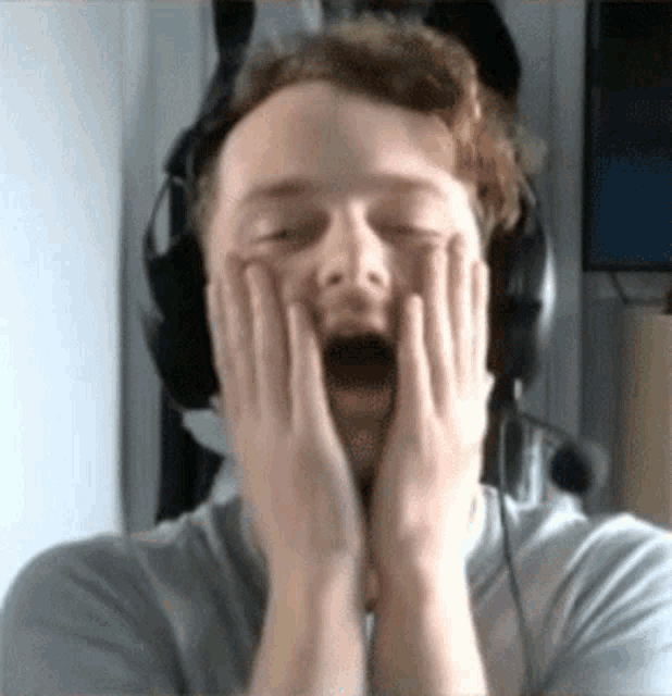 a man wearing headphones has his mouth open