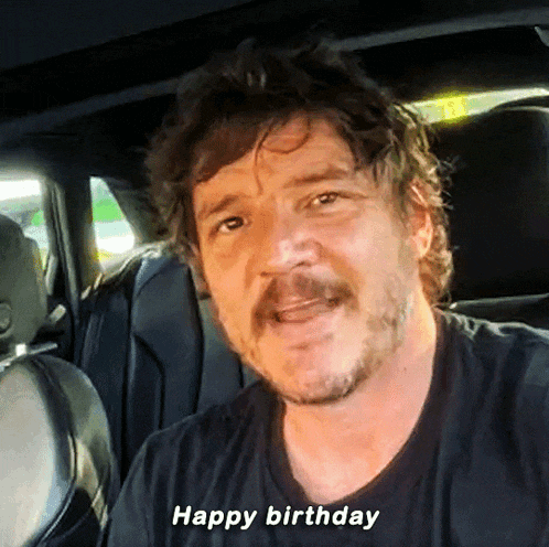 a man with a beard is sitting in the back seat of a car and says happy birthday