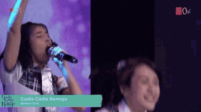 a woman singing into a microphone with the words gadis-gadis remaja written on the bottom