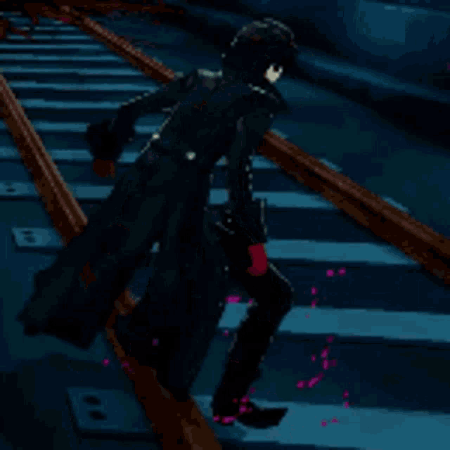 a man is walking down a set of train tracks with a gun in his hand .