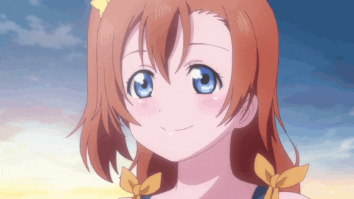 a girl with red hair and blue eyes is smiling for the camera