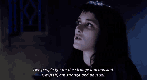 a woman in a black shirt is talking about strange and unusual things .