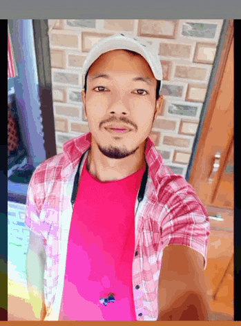 a man with a beard wearing a pink shirt and a white hat