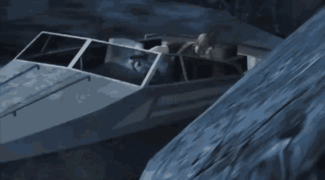 a boat is going down a cliff with a person sitting in it