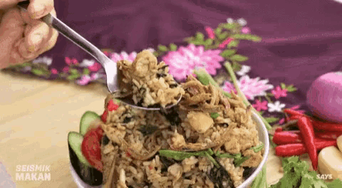 a person is eating a bowl of food with a spoon .