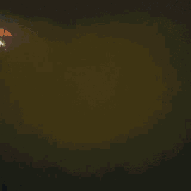 a person wearing a gas mask is standing in a dark room
