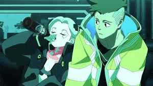 a man and a woman are sitting next to each other .