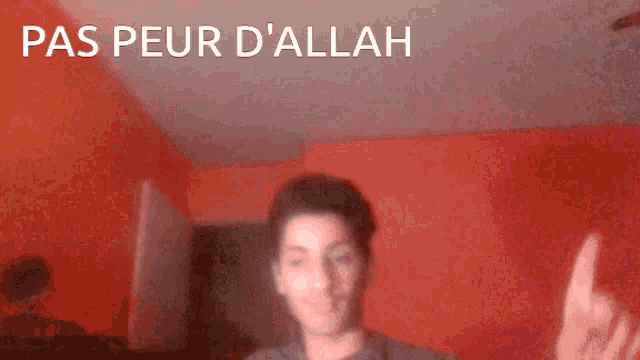 a man giving the middle finger with the words pas peur d' allah below him