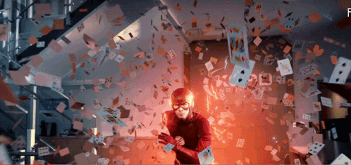 the flash is surrounded by playing cards with the letter f visible