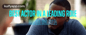 a man in a blue shirt with the words best actor in a leading role