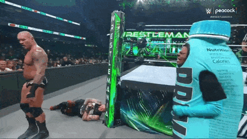 a wrestler is standing next to a bottle that says did