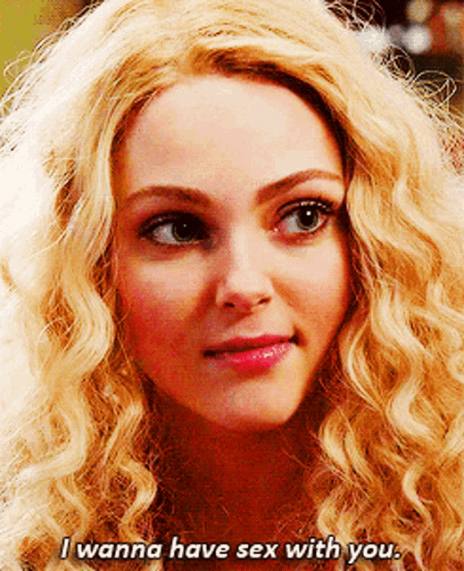 a woman with blonde curly hair is saying i wanna have sex with you