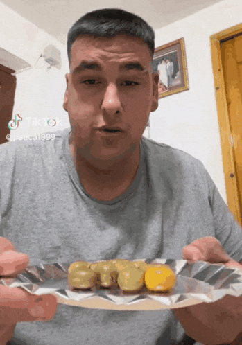 a man holding a plate of food with a tiktok watermark on the bottom