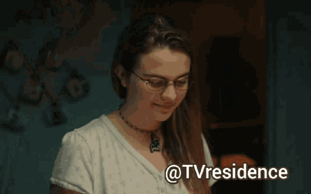 a woman blows out a single candle on a birthday cake with the words @tvresidence below it