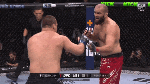 two men are fighting in a ufc ring and one of them is wearing red shorts that say griev