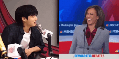 a man sitting in front of a microphone next to a woman in front of a microphone .