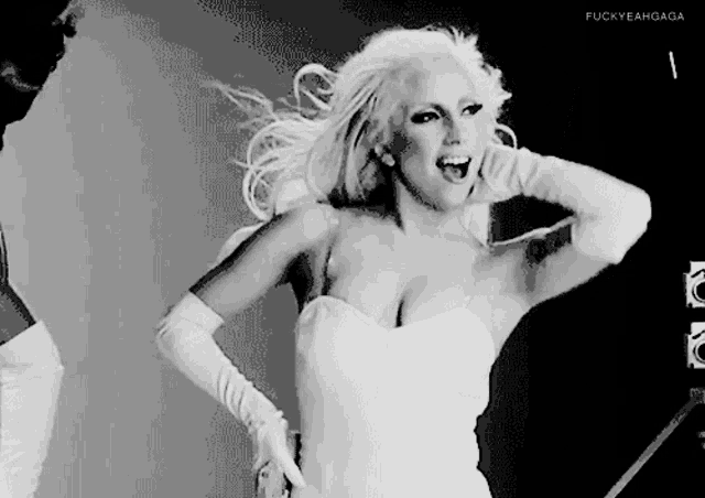 a black and white photo of a woman in a white dress