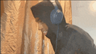 a person wearing headphones and a hooded jacket