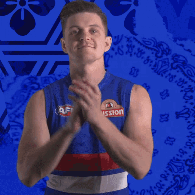 a man wearing a blue shirt that says afl mission is clapping his hands