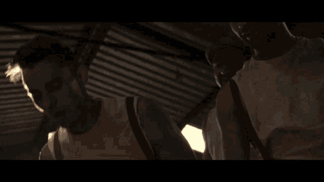 a man in a white shirt is standing under a ceiling
