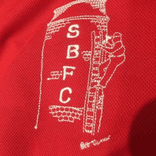 a red shirt with a white embroidered logo that says sbfc