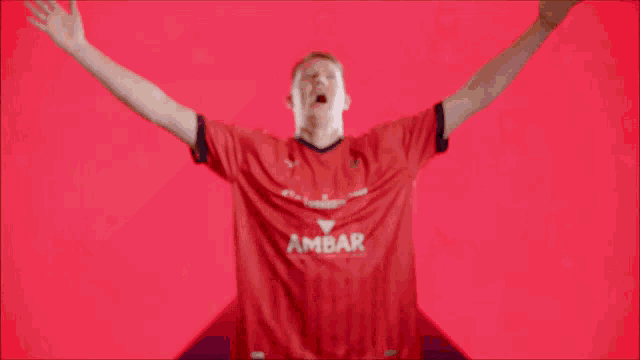 a blurry picture of a man in a red shirt that says ' bank of america '