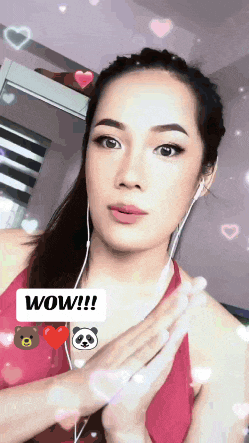 a woman wearing headphones and a red top says wow !!!