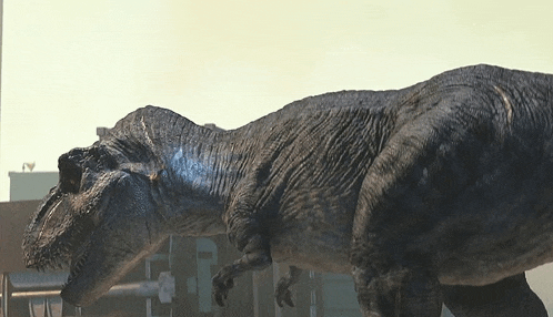 a t-rex is standing in front of a building