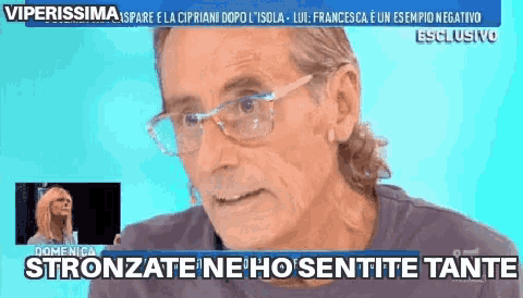 a man wearing glasses is talking on a television show