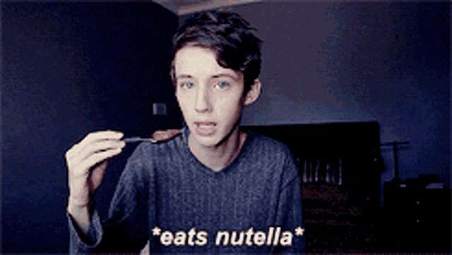 a young man is eating a piece of chocolate with the words " eats nutella " below him