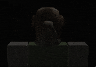 a statue of an owl is sitting on top of a green block in the dark