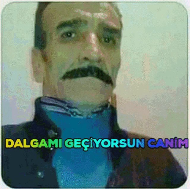 a man with a mustache and the words " dalgami geciyorsun canim " on the bottom