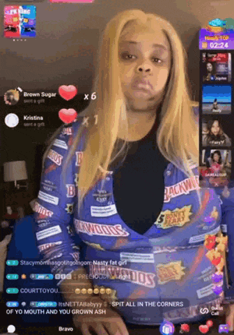 a woman wearing a blue shirt with backwoods on it