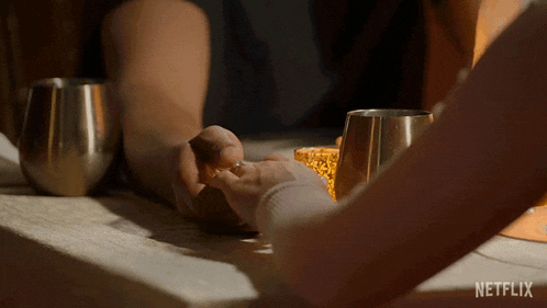 a person holding another person 's hand with a netflix logo in the corner