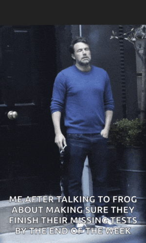 a man in a blue sweater is smoking a cigarette while standing in front of a door