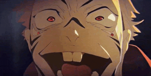 a close up of a man 's face with his mouth open and his tongue out .